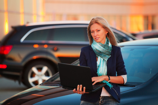 businesswoman-with-laptop-on-the-car-parking